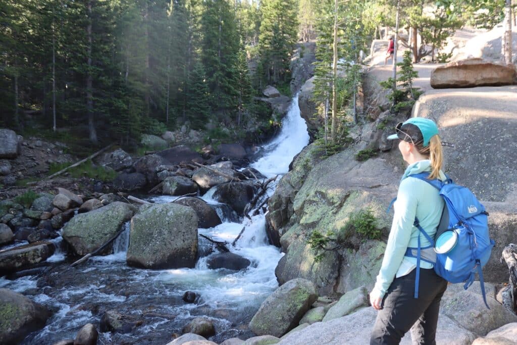 alex admiring alberta falls in rocky mountain national park